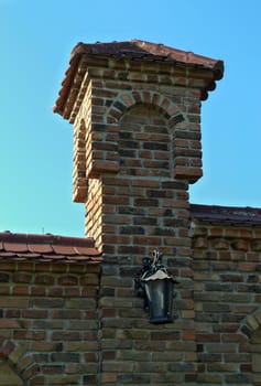 Small brick tower on monastery fence