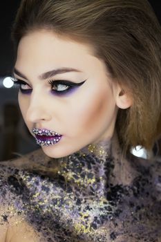 Fashion makeup. Woman with colorful makeup and body art.