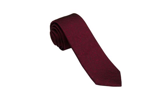 Closeup of an elegant stylish tie rolled and isolated on a white background.