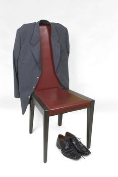 A jacket and a pair of shoes with a red chair