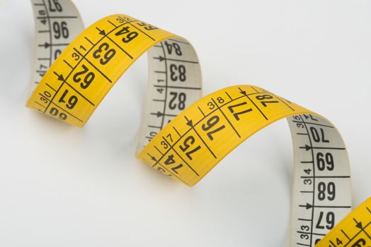 a yellow spiral tape measure