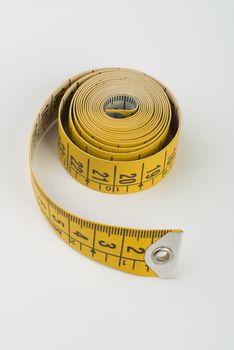 a yellow tape measure rolled up