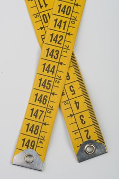 the heads of a yellow tape measure