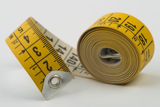 a yellow tape measure rolled up