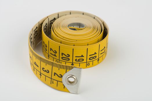 a yellow tape measure rolled up