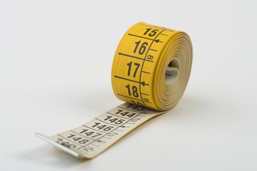 a yellow tape measure rolled up