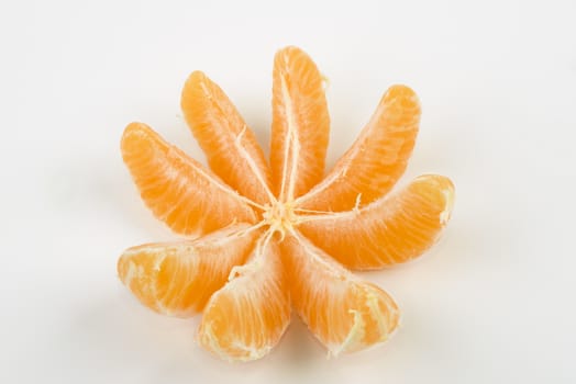 a peeled tangerine on a white table