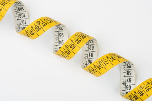 a yellow spiral tape measure