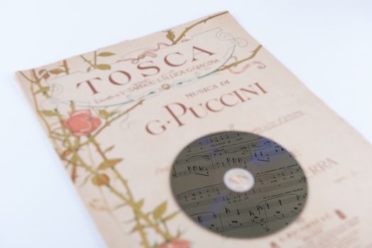 pages of the musical score and a cd