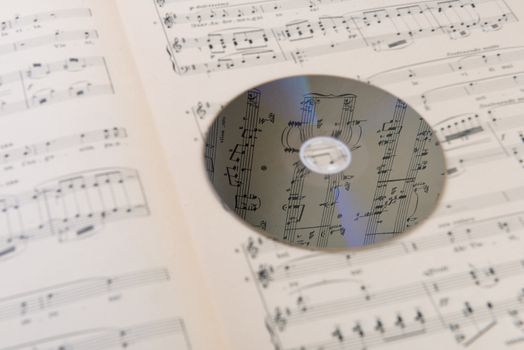 pages of the musical score and a cd