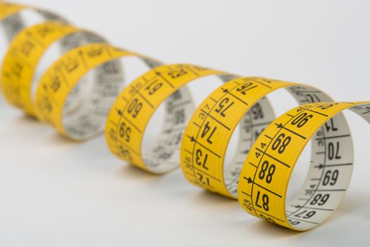 a yellow spiral tape measure