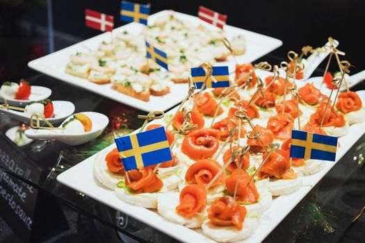 Trays with various delicious appetizer. Appetizer of fish.