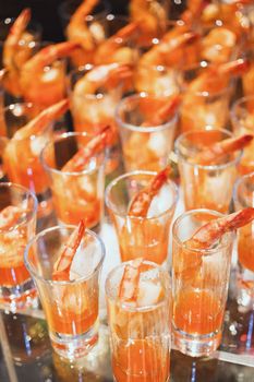 Shrimp cocktail in shot glass shot closeup.