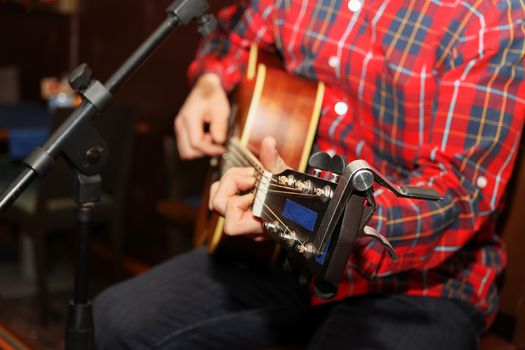 Acoustic guitar guitarist playing details. Musical instrument with performer hands.