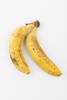 two bananas on a white table