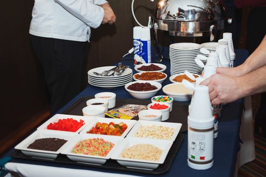 Male chef decorating tasty dessert in kitchen