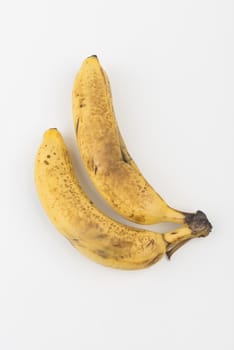 two bananas on a white table