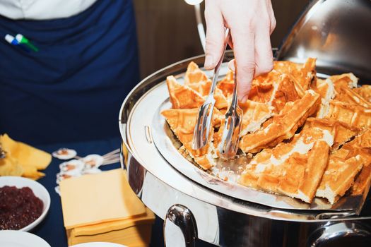 Male chef decorating tasty dessert in kitchen