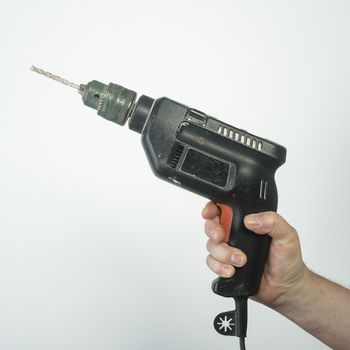 an electric drill in his hand