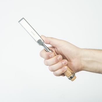 a chisel for wood in hand