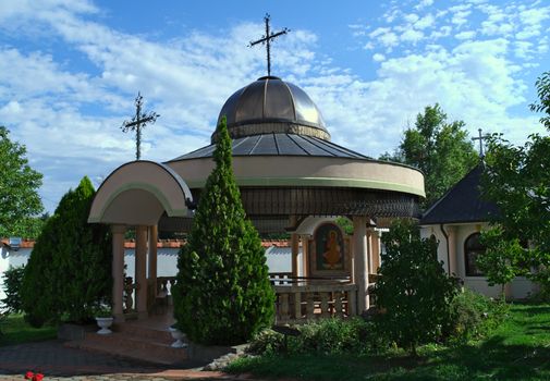 Small open chapel and decorative plants around it