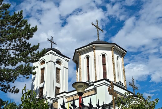 Two church towers, and cloudy sky in background