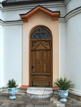 Decorated wooden front door of the church in Serbia