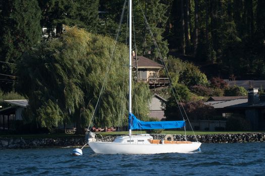 Small boat on buoy in Rich Passage on east side of Bainbridge Island, WA