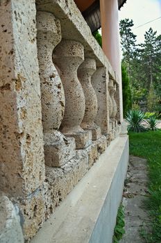 Concrete fence and garden around open chapel