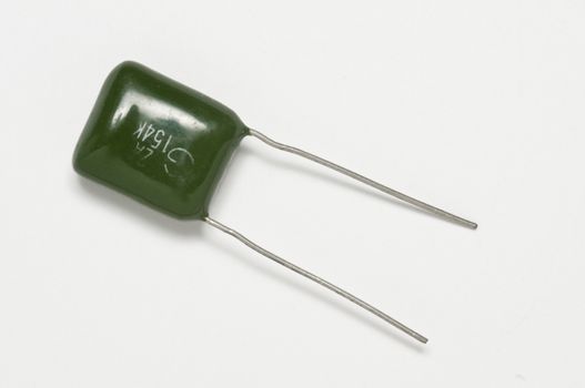 old colored capacitor on a white surface