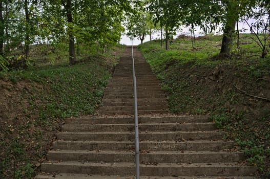 Concrete stairs going up to top of the hill