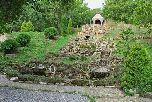 Big dry stone fountain and chapel on top of hill