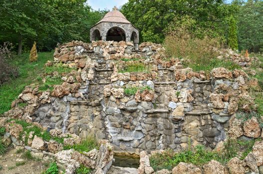 Big dry stone fountain and chapel on top of hill