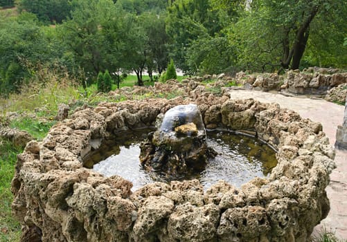 Small stone fountain on top of hill, looking down