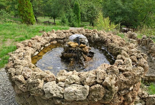 Small stone fountain on top of hill, looking down