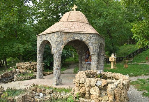 Small stone open chapel with two fountains