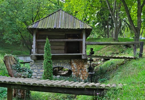 Old style wooden water mill in etno park