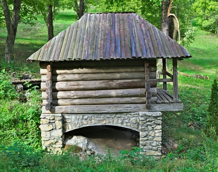 Old style wooden house in etno park from behind