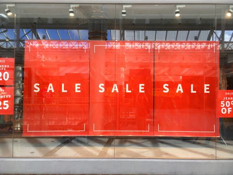Large simple shop banners advertising store SALE in shopfront window