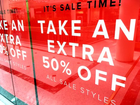 Shop front banner sign advertising a sale 50% off 