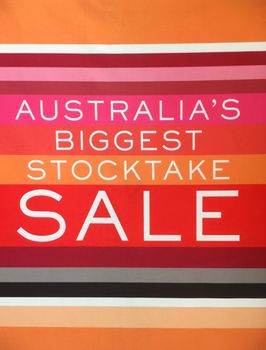 Stocktake sale sign banner hanging in a shop window