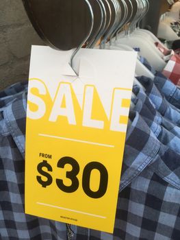 Racks of check shirts in sale in retail fashion shop