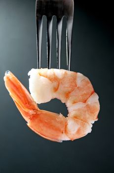 Close up of a cooked shrimp on fork 