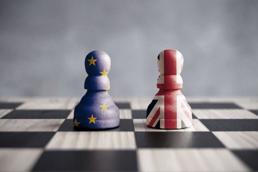 Two chess pawns with UK and European flags