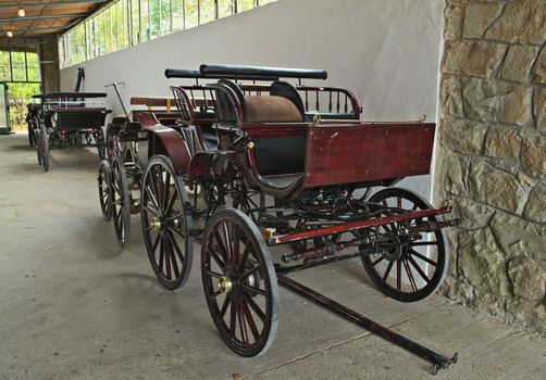 Vintage old style chariots in barn