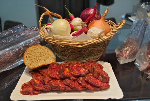 Dried sliced sausage and bread and basket