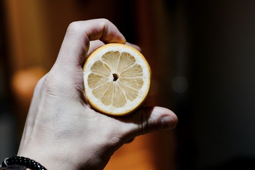 Yellow fresh lemon in man hand. Natural food concept. Fruits.