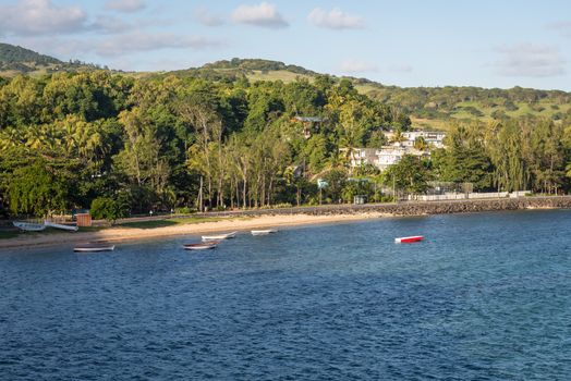 Nice view of mountain,trees,road,boats. and blue sea.Coast of Mauritius island