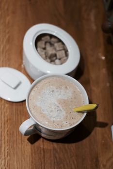 Fresh and tasty coffee in the kitchen on the wooden board. Drink concept.