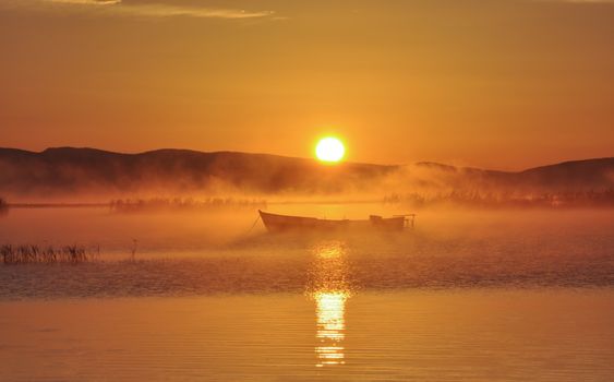 lake evaporation and fishing boat